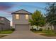 Charming two-story home featuring an attached two-car garage, well-maintained lawn, and mature trees at 6180 Spring Crayfish Ave, New Port Richey, FL 34653