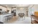 Bright and open kitchen flowing into the dining area with stainless steel appliances and bar seating at 6180 Spring Crayfish Ave, New Port Richey, FL 34653
