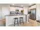Modern kitchen with white cabinets, stainless steel appliances, a center island, and bar stool seating at 6180 Spring Crayfish Ave, New Port Richey, FL 34653