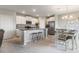 Open concept kitchen with white cabinets, stainless steel appliances, a dining area, and a kitchen island at 6180 Spring Crayfish Ave, New Port Richey, FL 34653