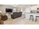 Living room connects to the kitchen with barstool seating, offering a modern and functional living space at 6180 Spring Crayfish Ave, New Port Richey, FL 34653
