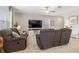 Comfortable living room with a large flat-screen TV and plush seating for relaxation and entertainment at 6180 Spring Crayfish Ave, New Port Richey, FL 34653