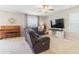 Cozy living room features a large flat-screen TV, comfortable seating, and a classic piano at 6180 Spring Crayfish Ave, New Port Richey, FL 34653