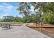 Community playground area with swings, slide, picnic table, and seating at 6180 Spring Crayfish Ave, New Port Richey, FL 34653