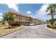 Exterior view of condominium complex with balconies, palm trees, and well maintained landscaping at 6400 46Th N Ave # 203, Kenneth City, FL 33709