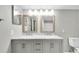 Bathroom featuring double sinks with marble countertop and two mirrors at 6400 46Th N Ave # 203, Kenneth City, FL 33709
