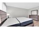 Bedroom featuring closet, light colored walls, and queen bed with gray headboard at 6400 46Th N Ave # 203, Kenneth City, FL 33709