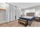 Bedroom featuring closet with white curtain, bench, and queen bed with gray headboard at 6400 46Th N Ave # 203, Kenneth City, FL 33709
