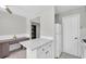 Bright kitchen with white cabinets, including a refrigerator and a breakfast bar at 6400 46Th N Ave # 203, Kenneth City, FL 33709