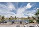 Community lake view from parking lot with mature palm trees, fountain, and multiple resident parking spots at 6400 46Th N Ave # 203, Kenneth City, FL 33709