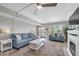 Inviting living room with view of tropical landscaping, complete with fireplace and comfortable seating at 6400 46Th N Ave # 203, Kenneth City, FL 33709