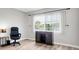 Office featuring desk, dark wooden cabinet, wood flooring, and natural light at 6400 46Th N Ave # 203, Kenneth City, FL 33709