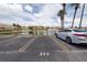 Parking spot view of complex lake with palm trees and neighboring apartment buildings at 6400 46Th N Ave # 203, Kenneth City, FL 33709