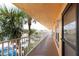 Open-air condo walkway featuring a secure entry door, offering a glimpse of community parking at 6400 46Th N Ave # 203, Kenneth City, FL 33709
