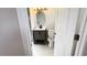 Angle view of bathroom with new vanity, toilet, and bright light above the vanity at 6407 1St Palm Pt, St Pete Beach, FL 33706