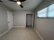 Bedroom with plush carpet, a ceiling fan, and an open closet, providing both comfort and functionality at 6407 1St Palm Pt, St Pete Beach, FL 33706