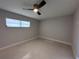 Bedroom featuring a ceiling fan and a window at 6407 1St Palm Pt, St Pete Beach, FL 33706