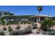 Charming home featuring a carport, a well-maintained front yard, and mature landscaping at 6407 1St Palm Pt, St Pete Beach, FL 33706