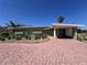 Charming home featuring a carport, a well-maintained front yard, and mature landscaping at 6407 1St Palm Pt, St Pete Beach, FL 33706