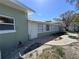 Rear exterior showcasing a clean and well-maintained home with a serene outdoor brick patio at 6407 1St Palm Pt, St Pete Beach, FL 33706