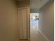 View of hallway leading to kitchen with a louvered door closet at 6407 1St Palm Pt, St Pete Beach, FL 33706