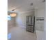 Stainless steel refrigerator and elegant chandelier lighting adorn this kitchen space at 6407 1St Palm Pt, St Pete Beach, FL 33706
