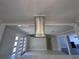 Contemporary kitchen features a modern stainless steel range hood and open layout at 6407 1St Palm Pt, St Pete Beach, FL 33706