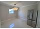 Bright kitchen features a stainless steel refrigerator and elegant chandelier lighting at 6407 1St Palm Pt, St Pete Beach, FL 33706
