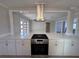 A bright, open-concept kitchen features white cabinets, a cooking island, and stainless steel appliances at 6407 1St Palm Pt, St Pete Beach, FL 33706