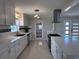 An updated kitchen displays white cabinets, stainless steel appliances, and plenty of countertop space at 6407 1St Palm Pt, St Pete Beach, FL 33706