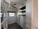 A tidy laundry room offers shelving and natural light, enhancing its utility and practicality at 6407 1St Palm Pt, St Pete Beach, FL 33706