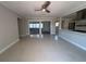 Open-concept living room showcases polished floors with views of the kitchen and ample natural light at 6407 1St Palm Pt, St Pete Beach, FL 33706