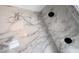 Angle view of shower with marble-style walls and dual rain style shower heads at 6407 1St Palm Pt, St Pete Beach, FL 33706