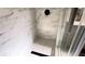 Angle view of shower with marble-style walls, hexagon style floor, and dual rain style shower heads at 6407 1St Palm Pt, St Pete Beach, FL 33706