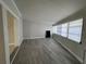 Bright sunroom featuring wood-look flooring, and many windows offering natural light at 6407 1St Palm Pt, St Pete Beach, FL 33706