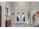 Bright foyer featuring double doors leading to the outdoor living space and elegant decor at 6741 51St N Way, Pinellas Park, FL 33781
