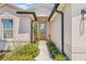 Home featuring a charming entryway, complete with beautiful landscaping and a well-lit porch at 6741 51St N Way, Pinellas Park, FL 33781