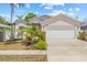 Charming single-story home with a two-car garage and a well-manicured lawn, showcasing curb appeal at 6741 51St N Way, Pinellas Park, FL 33781