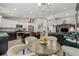 Open-concept living space with a kitchen island, white cabinetry, and modern lighting at 6741 51St N Way, Pinellas Park, FL 33781