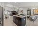 Open living space with a kitchen island and lots of natural light, creating a warm, inviting atmosphere at 6741 51St N Way, Pinellas Park, FL 33781