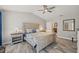 Comfortable main bedroom with a ceiling fan, side tables, and ocean-themed decor at 6741 51St N Way, Pinellas Park, FL 33781