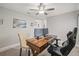 Comfortable office area showcasing a ceiling fan and a wooden desk with dual monitors and ergonomic seating at 6741 51St N Way, Pinellas Park, FL 33781
