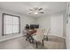 Office with wood flooring, ceiling fan, large window, and spacious closet, complete with a wooden desk and chairs at 6741 51St N Way, Pinellas Park, FL 33781