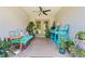 Outdoor patio with wicker furniture, colorful cushions, and an array of potted plants for a serene retreat at 6741 51St N Way, Pinellas Park, FL 33781