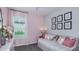 Cozy bedroom featuring neutral walls, daybed, and window at 721 Steel Dr, Apollo Beach, FL 33572