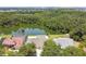 Aerial view of the property with a serene lake, lush greenery, and neighborhood views at 7246 Bucks Ford Dr, Riverview, FL 33578