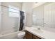 Standard bathroom featuring a bathtub with shower, single sink vanity, and tiled walls at 7246 Bucks Ford Dr, Riverview, FL 33578