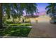 Inviting home showcasing a three car garage, manicured lawn, and mature trees in a desirable neighborhood at 7246 Bucks Ford Dr, Riverview, FL 33578