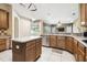 Open kitchen with island, stainless steel dishwasher, and views into the Gathering room at 7246 Bucks Ford Dr, Riverview, FL 33578