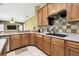 Kitchen featuring tile backsplash, gas range and stainless steel dishwasher, with a view to the Gathering room at 7246 Bucks Ford Dr, Riverview, FL 33578